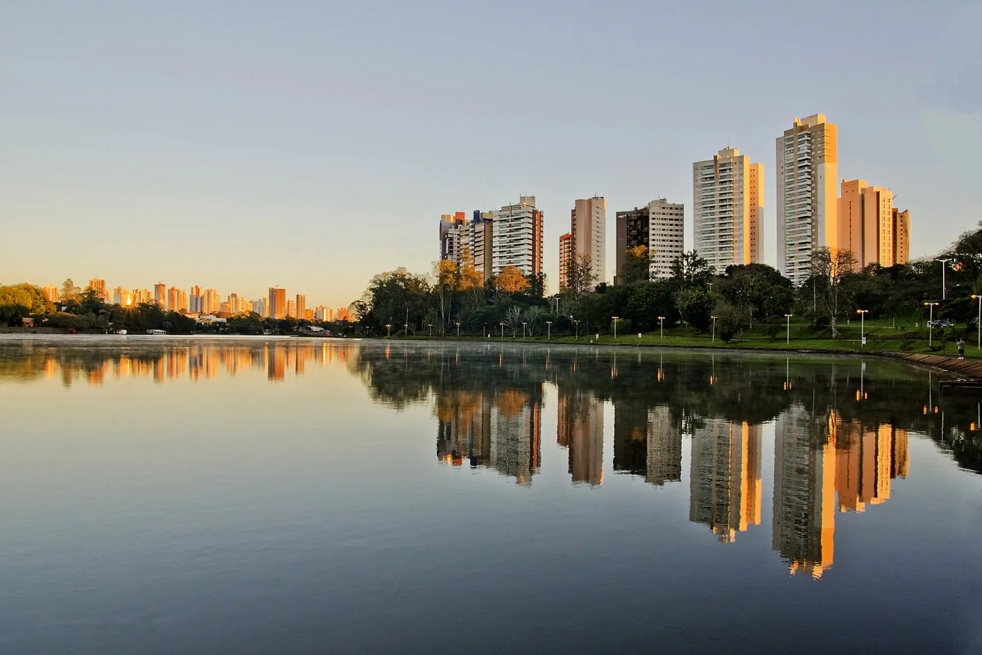 A modern, abstract architectural detail or cityscape representing Londrina, Brazil. High-contrast, vibrant, with subtle neon lighting accents against a bright sky to maintain the energetic, modern travel aesthetic. The image serves as an engaging backdrop.