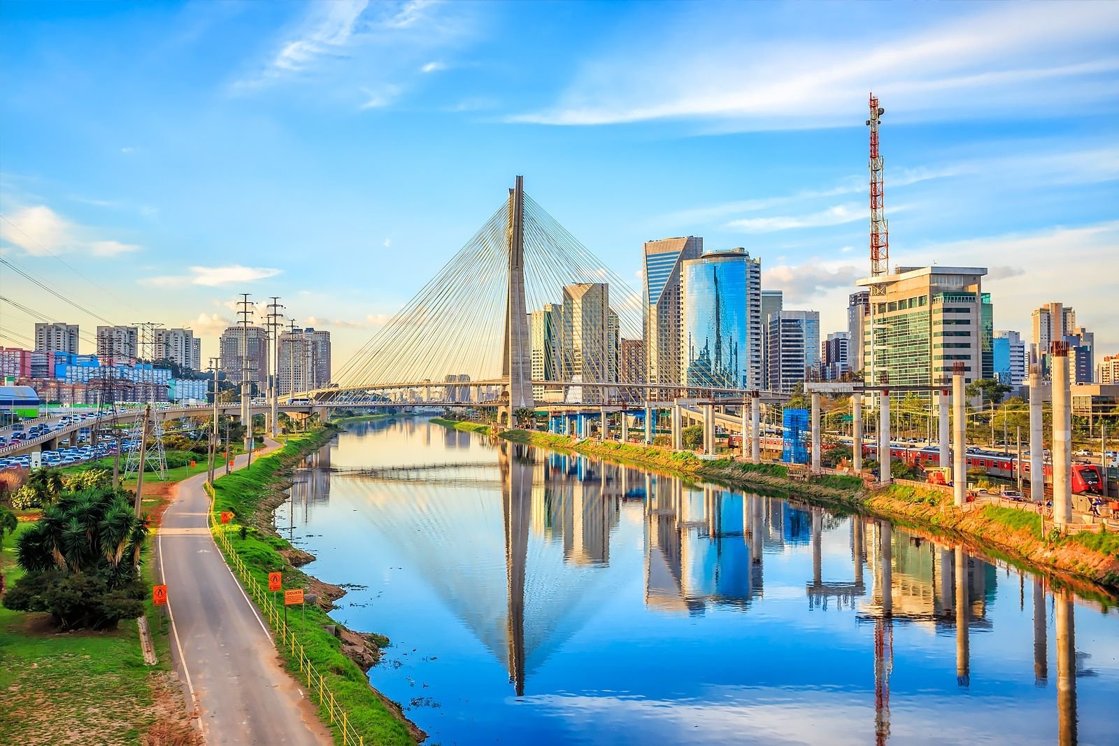A modern, abstract architectural detail or cityscape representing São Paulo, Brazil. High-contrast, vibrant, with subtle neon lighting accents against a bright sky to maintain the energetic, modern travel aesthetic. The image serves as an engaging backdrop.